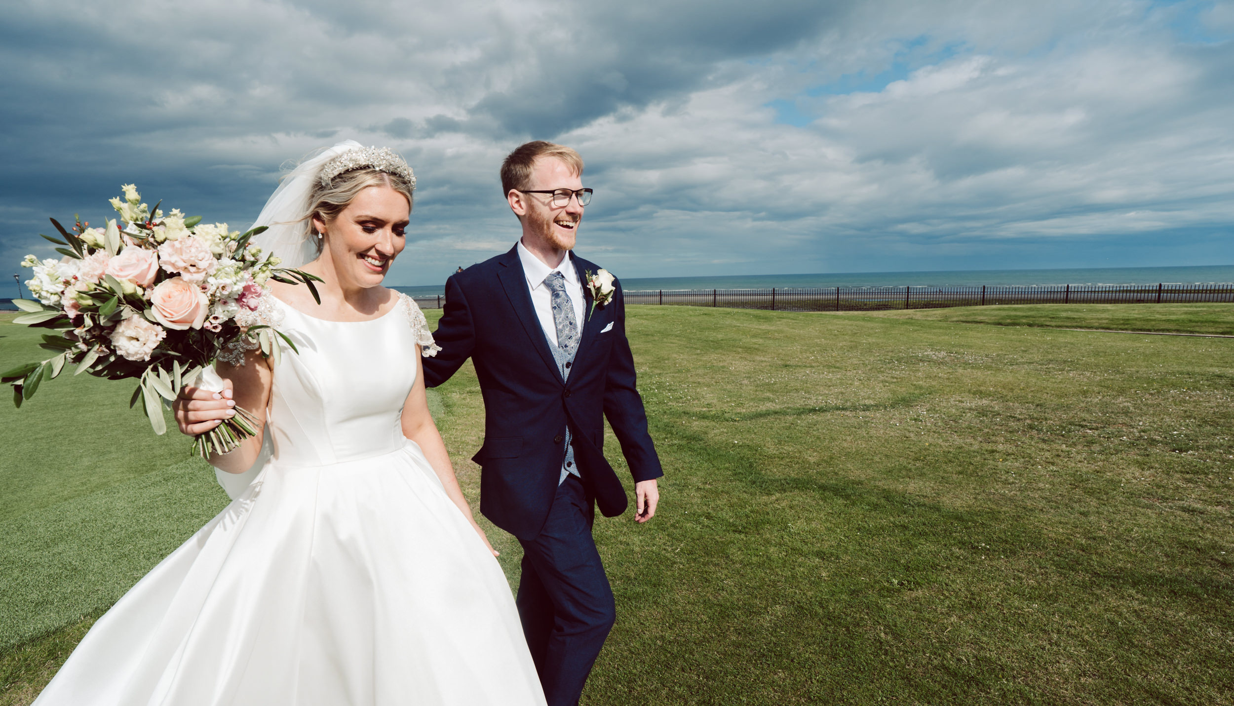 Bride & Groom pictured walking at Slieve Donard Hotel in Newcastle County Down
